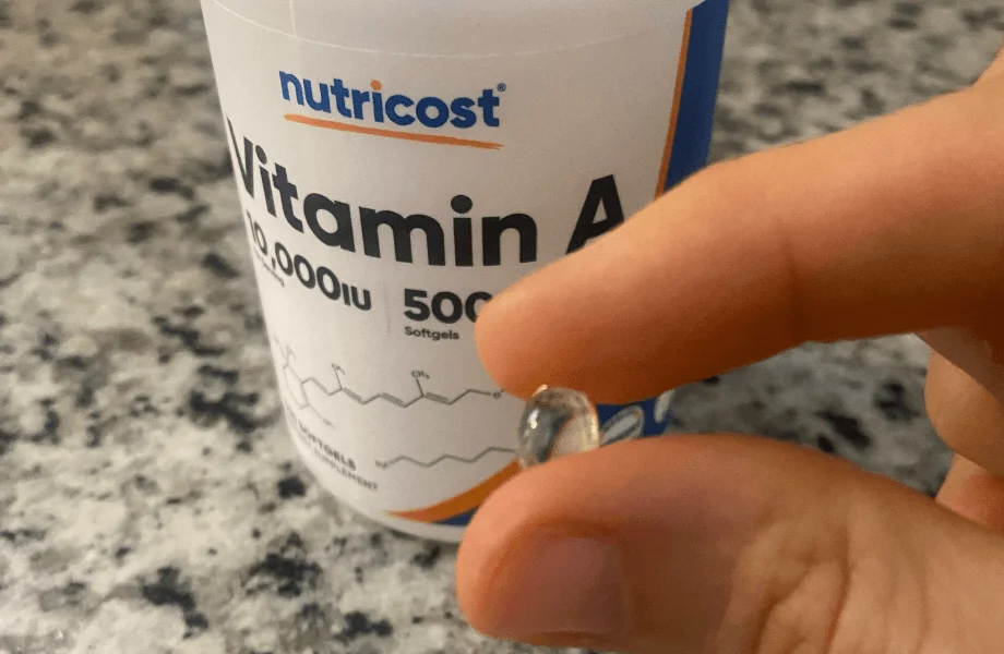 Our tester holding a single capsule of Nutricost Vitamin A 10,000 IU Softgels