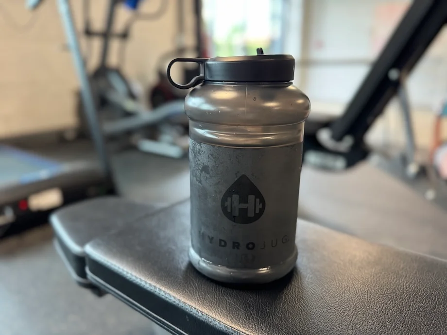 HydroJug Pro Jug V2 on top of a weight bench
