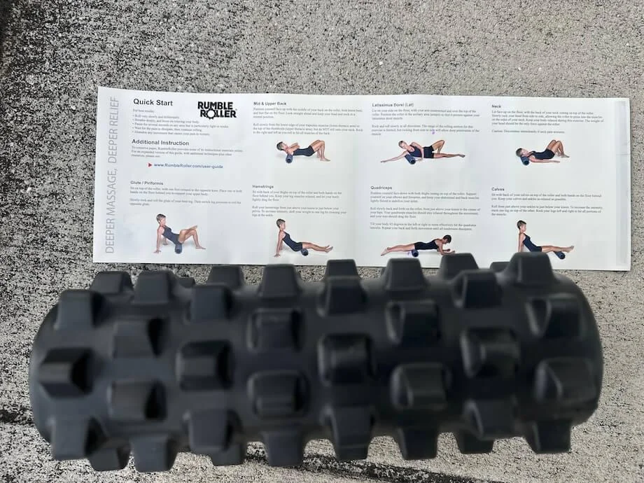 The Rumble Roller next to it's Quick Start guide insert.