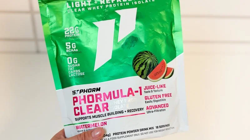 A hand holding a bag of 1st Phorm Phormula-1 Clear Protein Powder A hand holding a bag of 1st Phorm Phormula-1 Clear Protein Powder