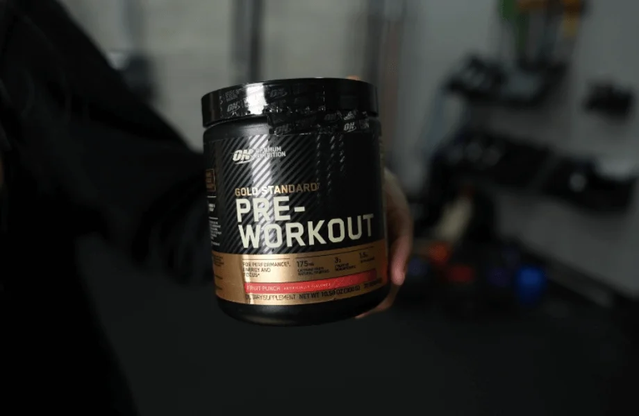 Our tester holding a container of Optimum Nutrition Gold Standard Pre-Workout