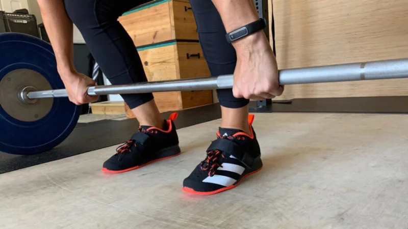 A person sets up for a clean in adidas Adipower 2 shoes