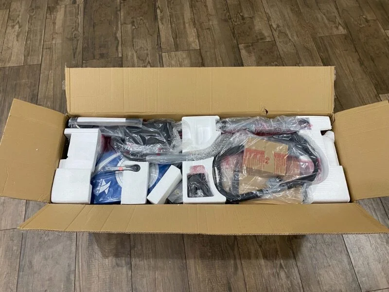 A box with the unassembled parts of the XTERRA folding exercise bike