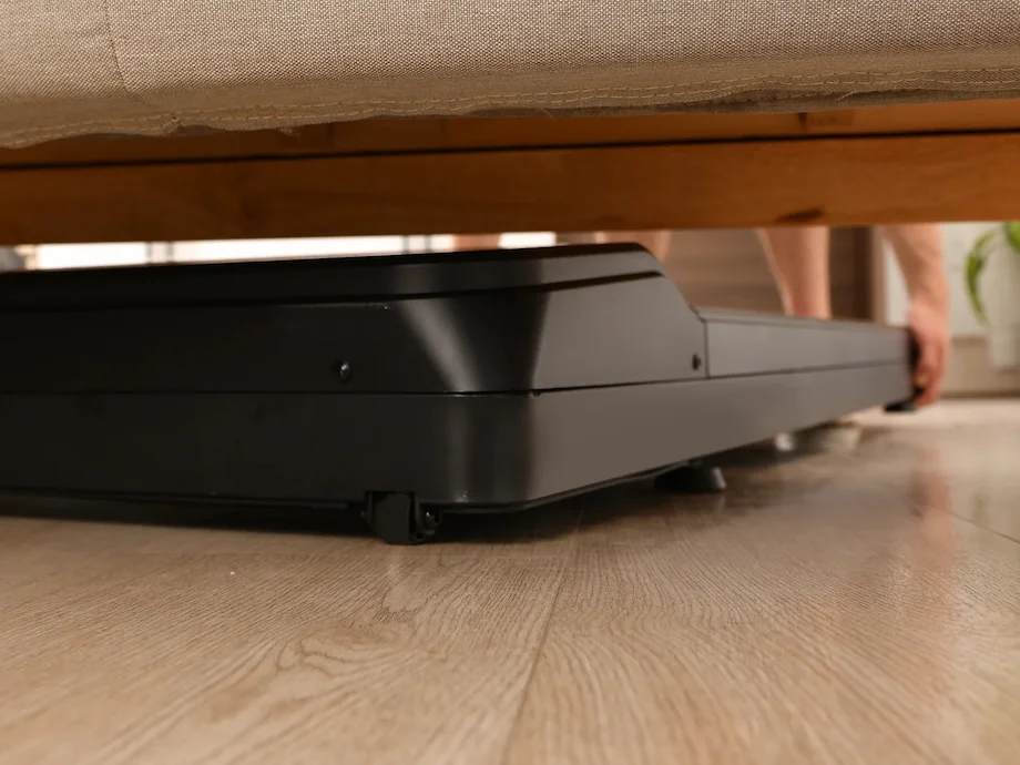 TR1200-stored A side view of the LifeSpan TR1200 treadmill stowed away under a bed.