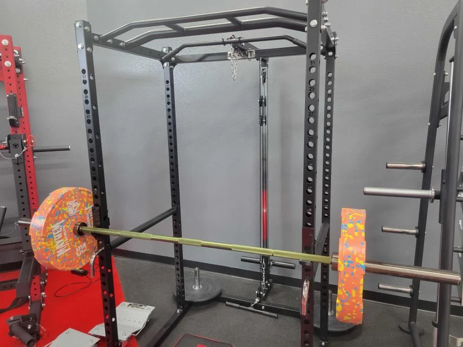 A barbell resting on the Giant Lifting Garage Gym Power 2.0 Rack