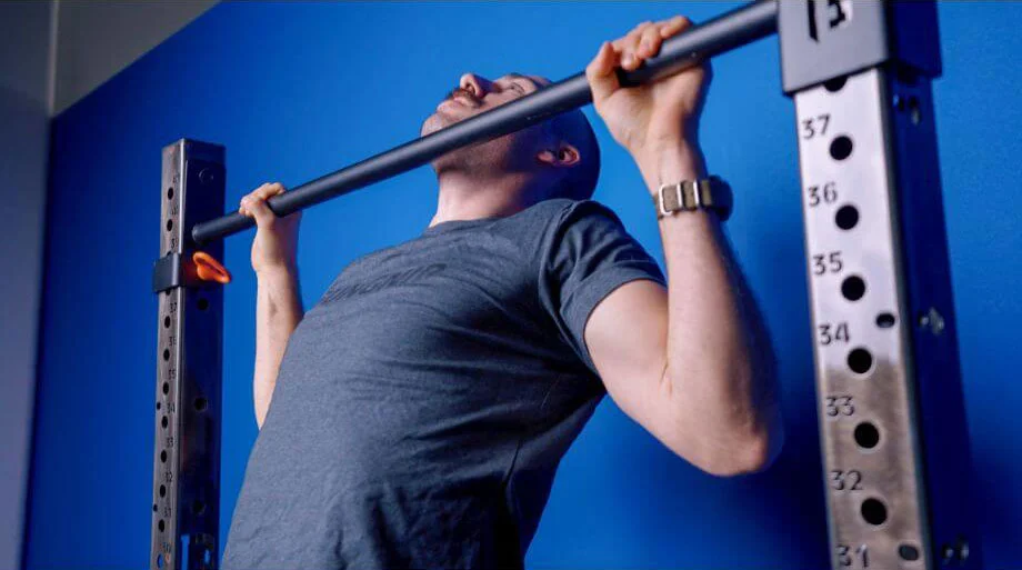 person using horizontal bar on rack