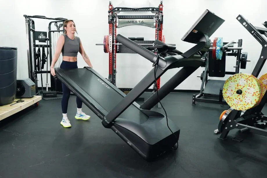 Lindsay Scheele, CPT moving an Aviron Victory Treadmill