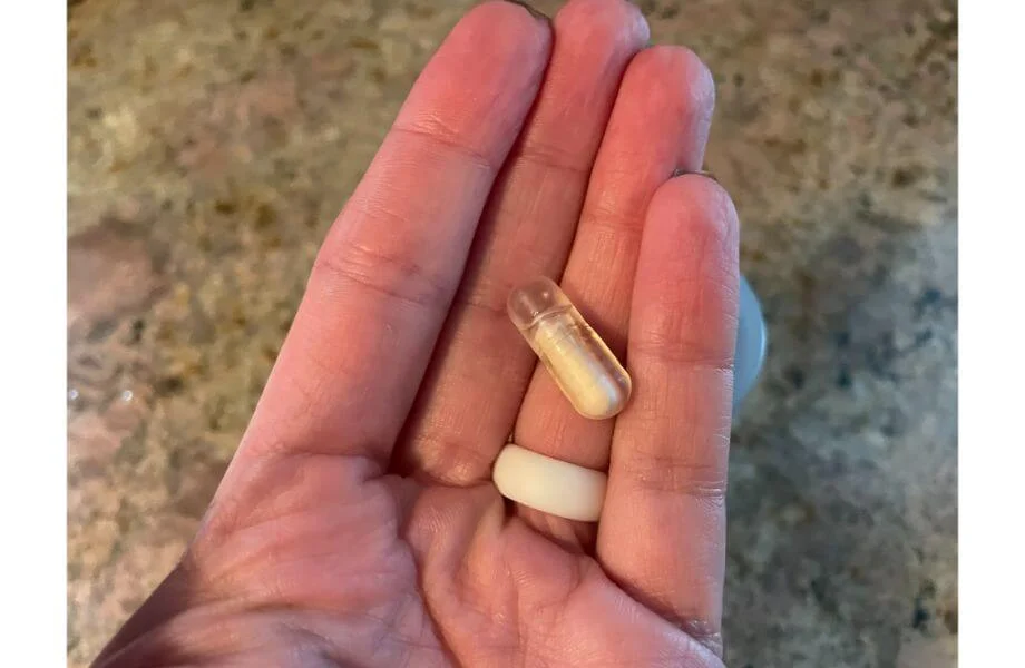 Our tester holding a single serving of probiotic capsules