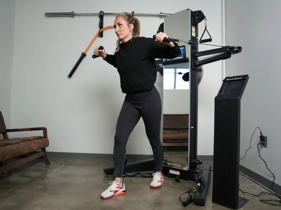 Full view of someone working out on the NordicTrack Fusion CST machine.