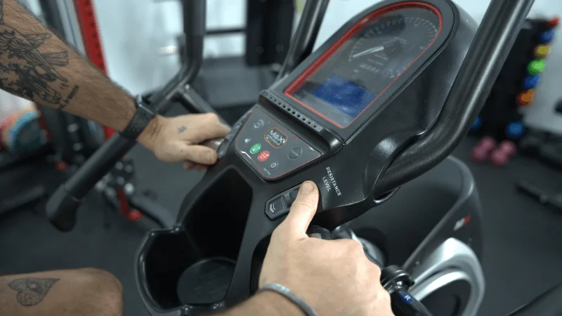 Our tester adjusting their resistance settings on the Bowflex Max Trainer M6