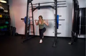 woman doing split squats in titan smith machine