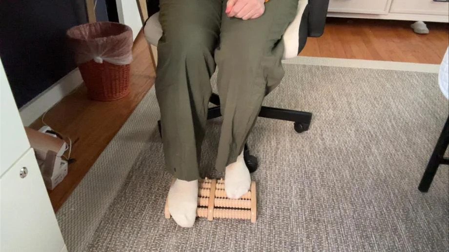 A person uses a Theraflow Foot Roller