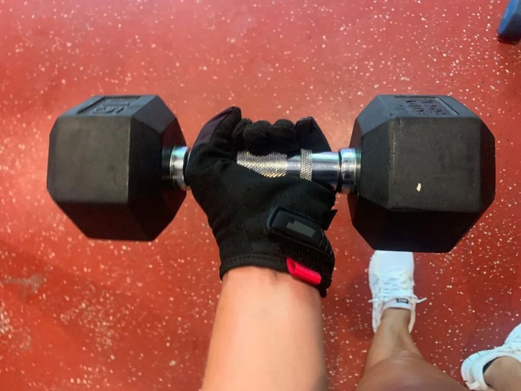 Mechanix Gloves holding a hex dumbbell