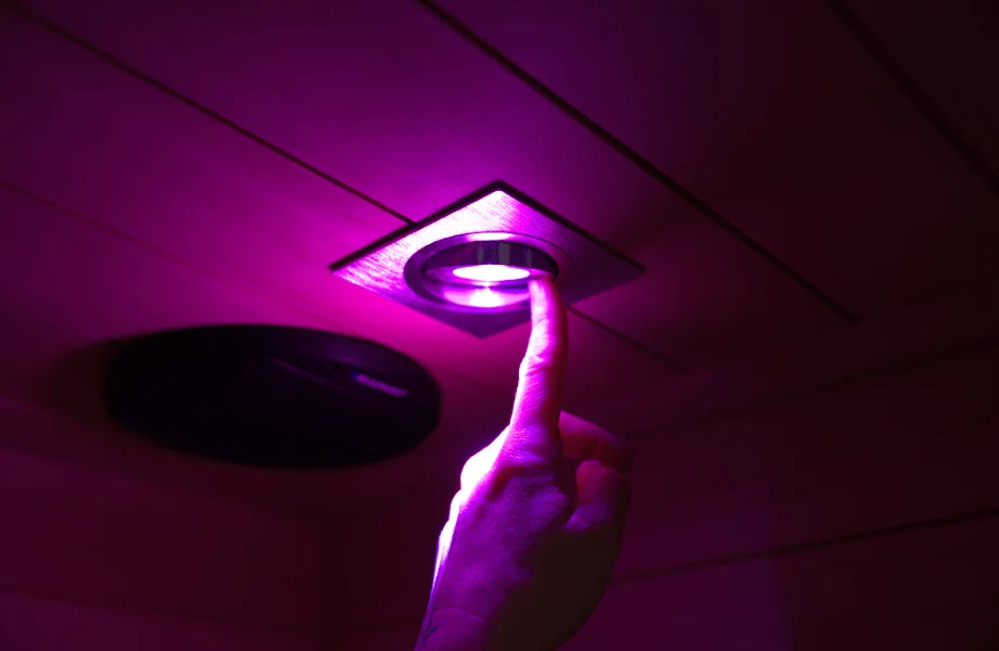 Our tester adjusting the chromotherapy lighting found in the Sun Home Equinox infrared sauna