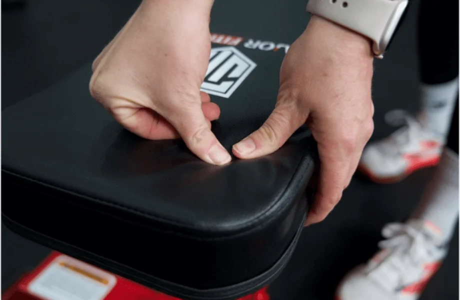 Our tester examining the back pad thickness and firmness on the Major Fitness Adjustable Bench