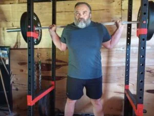 man holding dmoose regional barbell