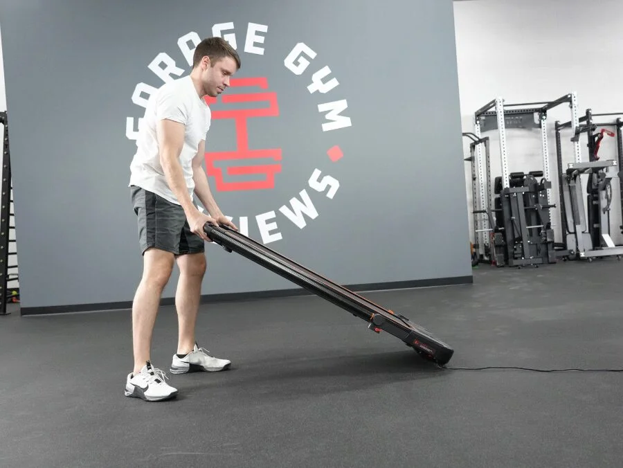 The UREVO treadmill being moved by Nathan