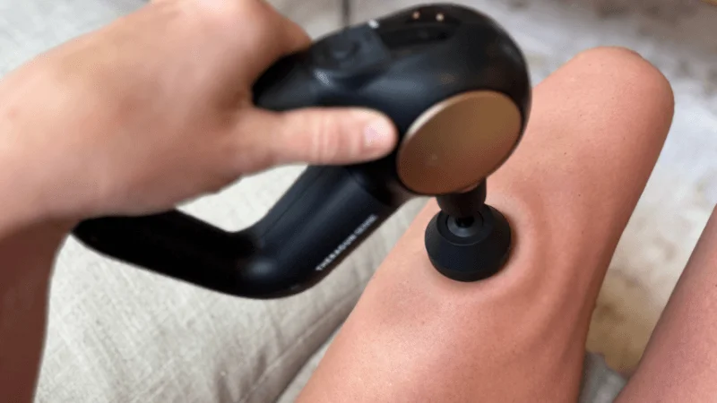 Our tester using the Therabody Theragun Sense on their thigh
