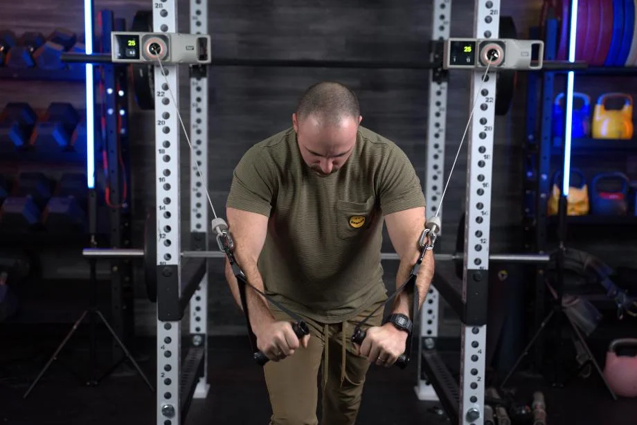 A man works out with the Beyond Power Voltra I.