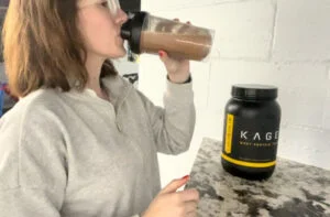 woman drinking kaged whey isolate 1