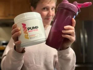 RAW Pump Pre Workout woman holding container