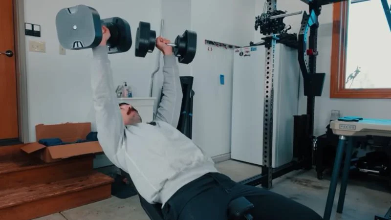 A man benching with the MX100 Evo Series Dumbbells