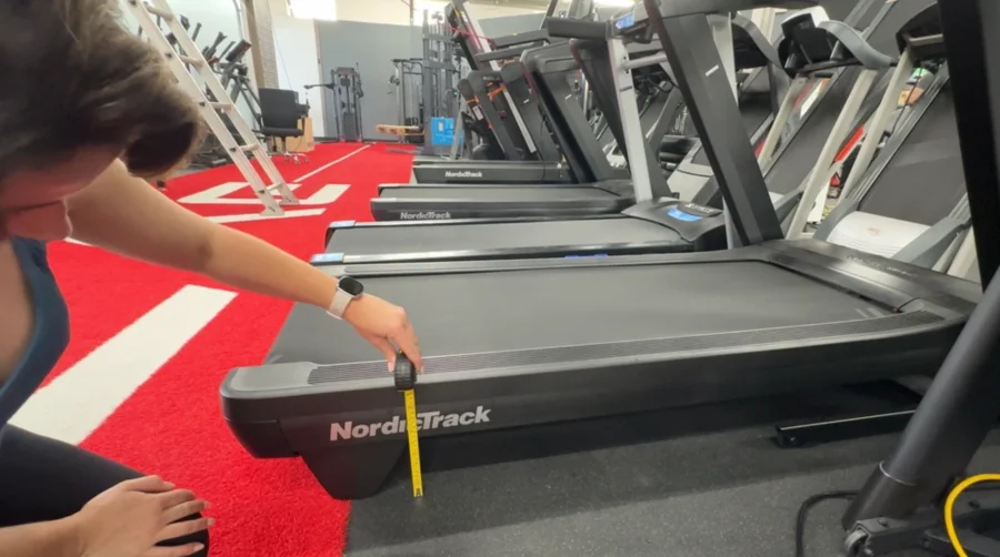 Our tester measuring the step-up height of the NordicTrack Commercial 1750 treadmill.