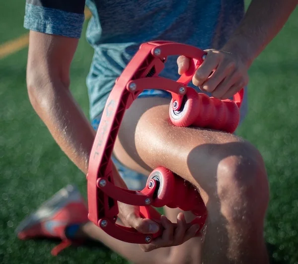 Image of someone using the Roll Recovery R8 in red on their leg