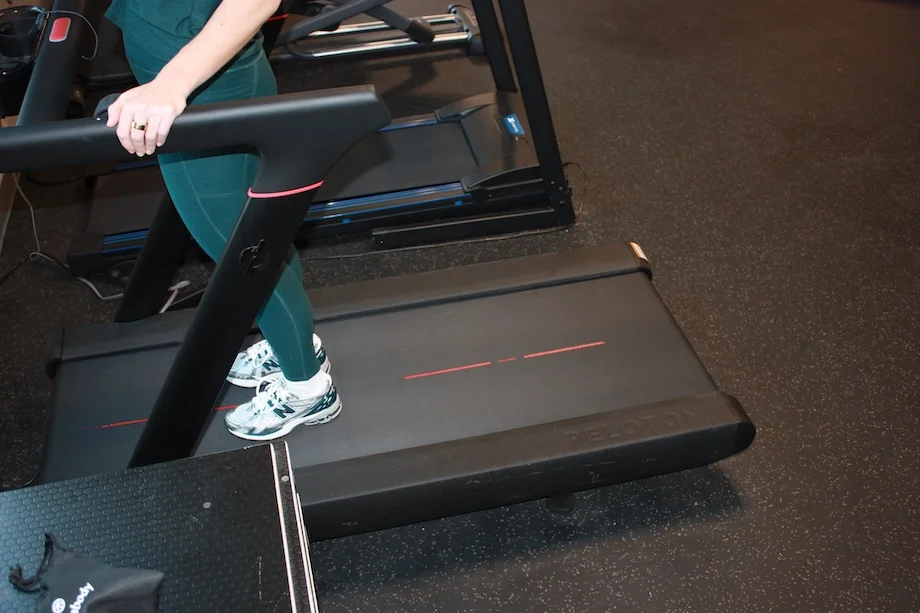 A person standing on a Peloton Tread