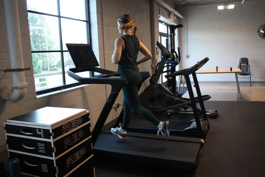 A product tester jogging on the Peloton Tread