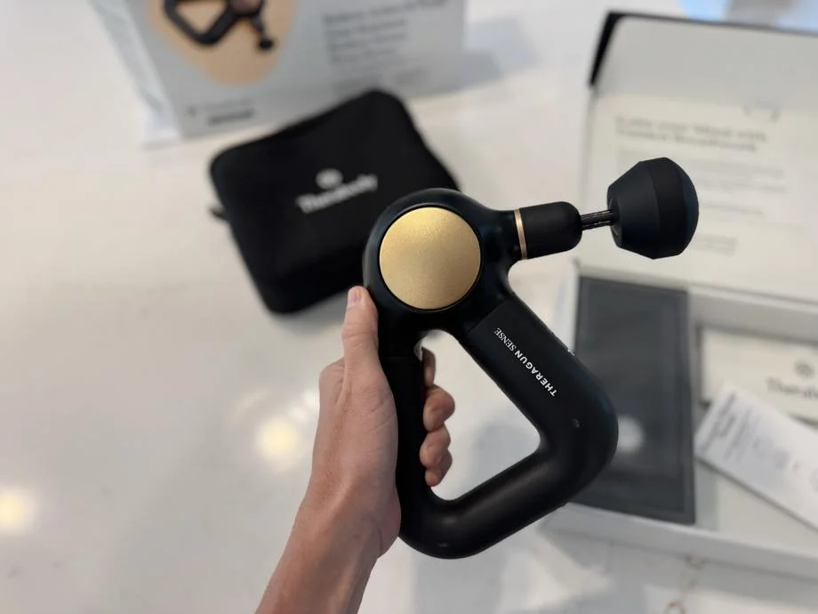 Our tester holds up a Therabody Theragun Sense