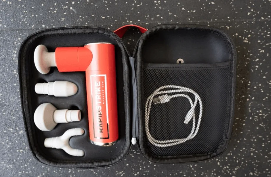 The REP Rapidstrike Massage Gun in its portable carrying case