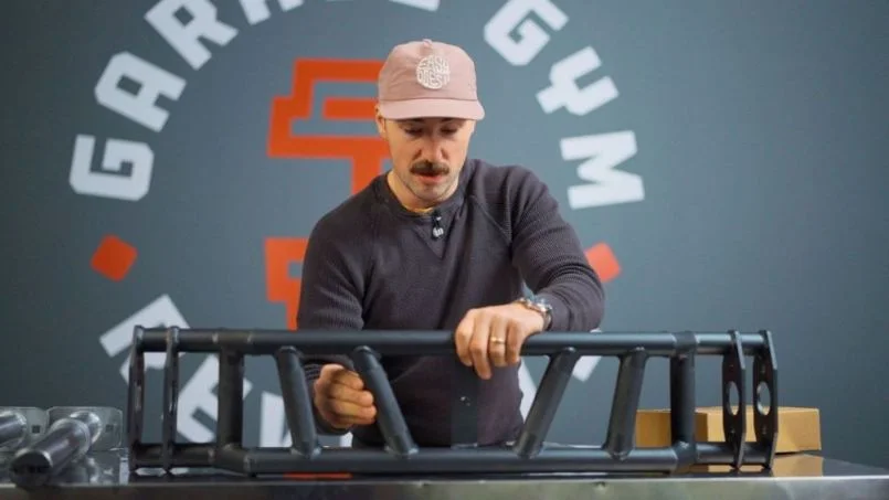 Coop holding the REP Fitness Cambered Swiss Bar