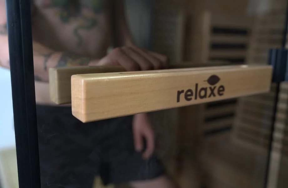 Our tester opening the clear glass door of the Relaxe Caldera Infrared Sauna