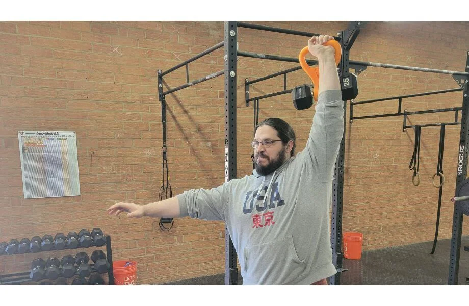 Performing a kettlebell jerk with the Kettle Gryp