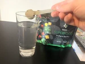 texas superfood review man scooping powder