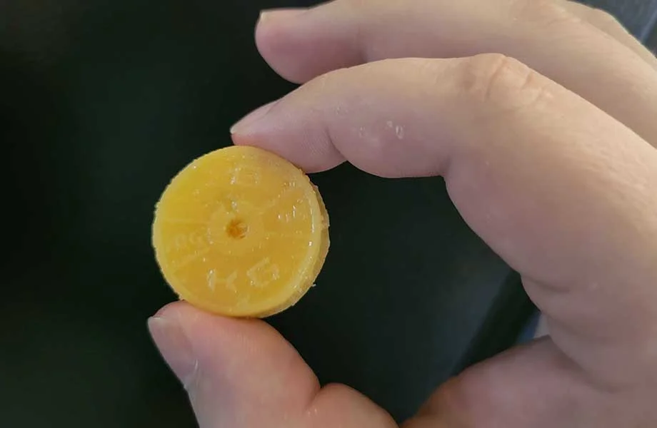 A hand holds up a Kodagenix Pre-Workout Gummy.