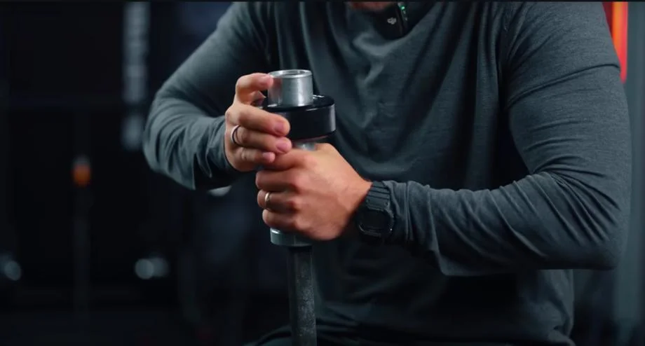 Coop tightening Titan TwistLock Barbell Collars.