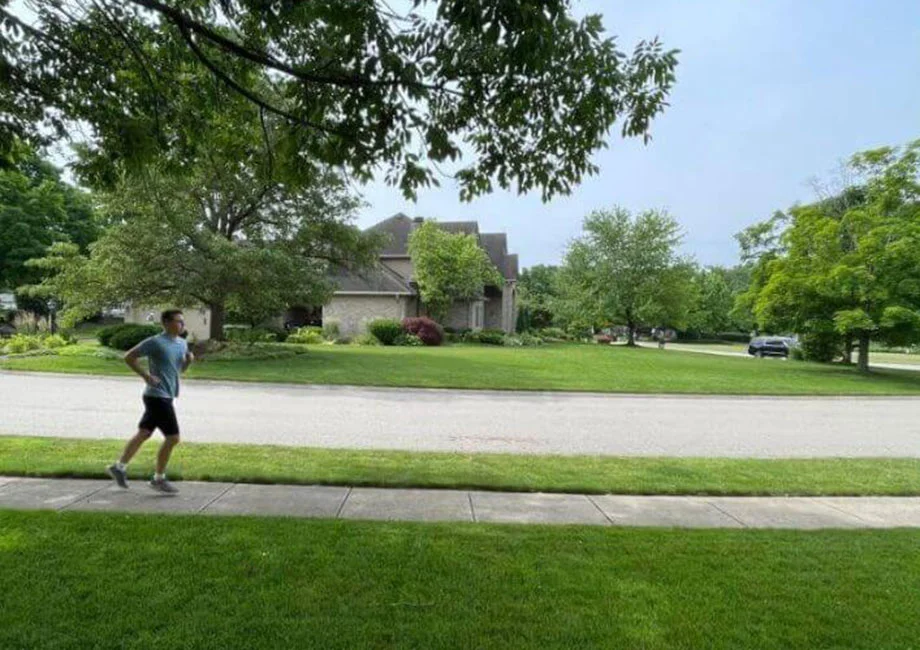 A man running in a suburban neighborhood