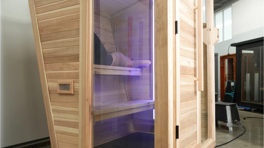 Looking through the window of the Plunge Sauna at our tester on the inside.