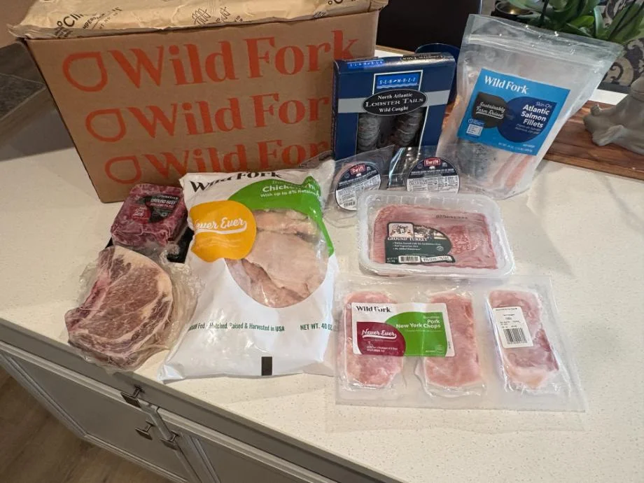 Contents of a Wild Fork meat delivery unboxed on top of a counter