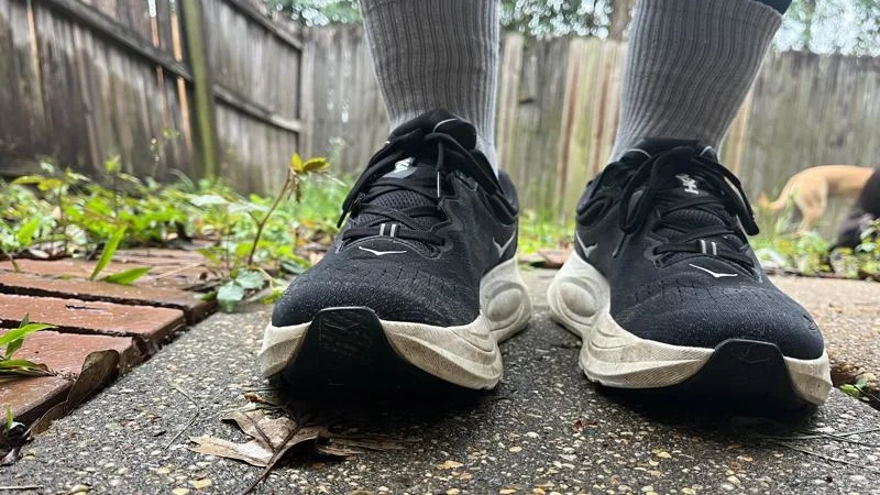 Front view of a person wearing a pair of HOKA Gaviota 6 recovery shoes.