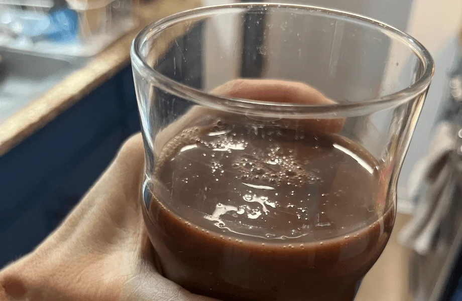 Our tester holding a glass of Muscle Milk Zero Protein Shake