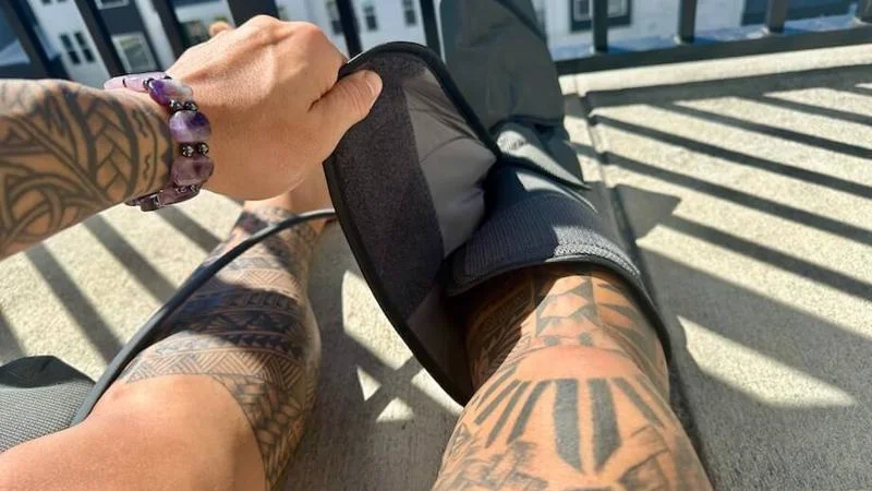Our tester strapping into a pair of FIT KING Leg Air Massager compression boots