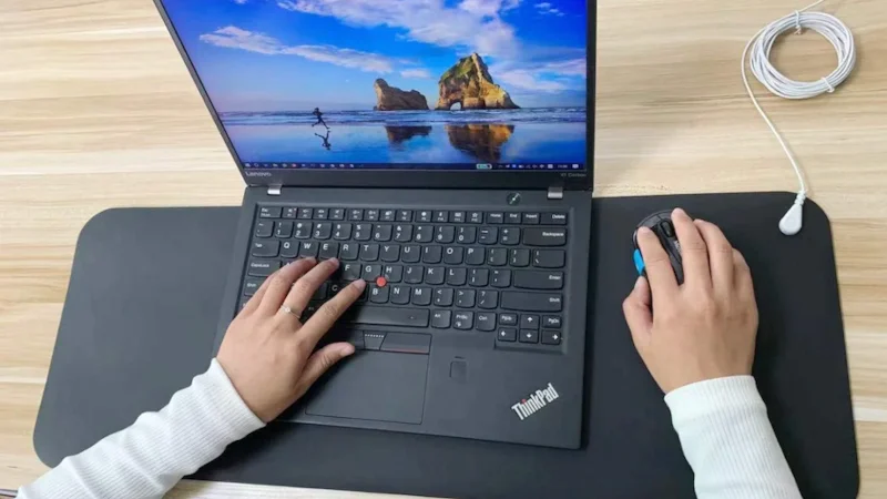 Terra Grounding Mat positioned under a laptop as a woman works