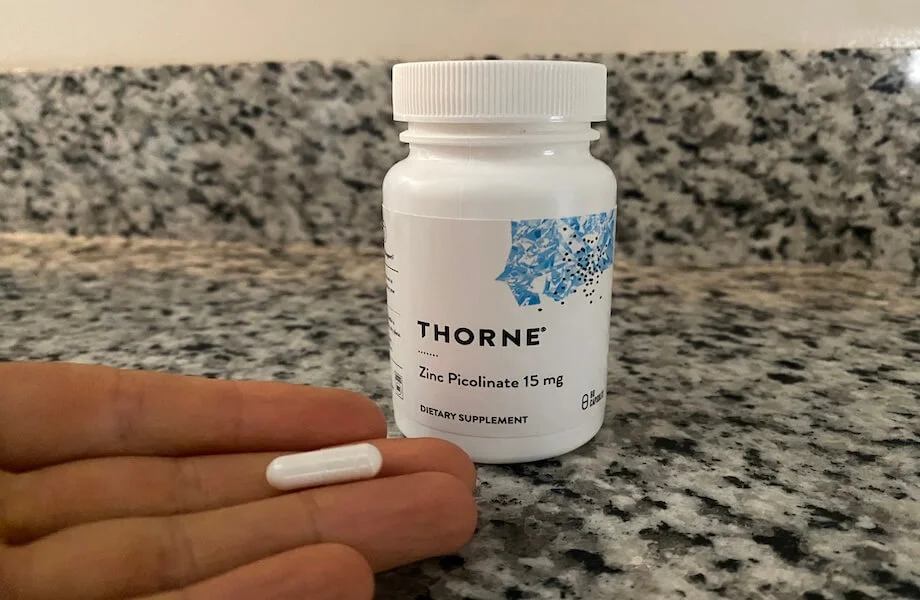 Our tester holding a capsule of Thorne Zinc Picolinate