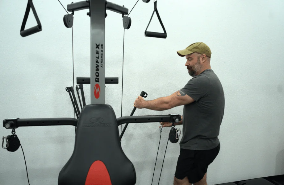 Our tester adjusting the rod system of the Bowflex Xtreme 2 SE Home Gym
