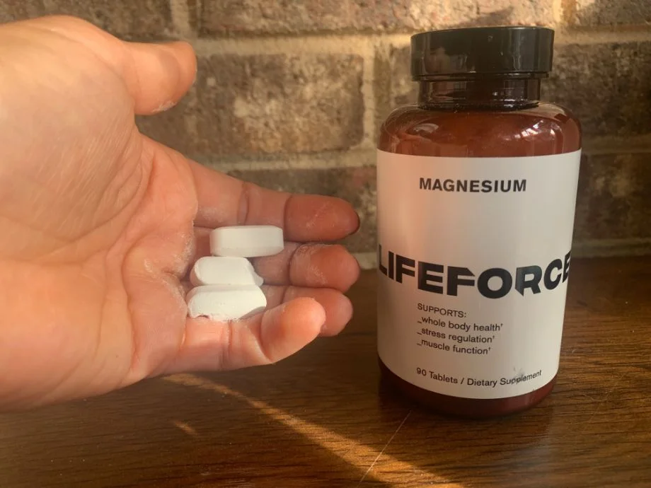 Our tester holds some LifeForce Magnesium pills next to the bottle
