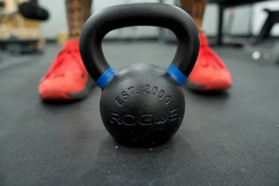 Rogue E-Coat kettlebell on the floor in front of a product tester
