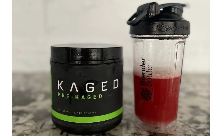 Kaged Pre Kaged Pre Workout container next to a shaker cup